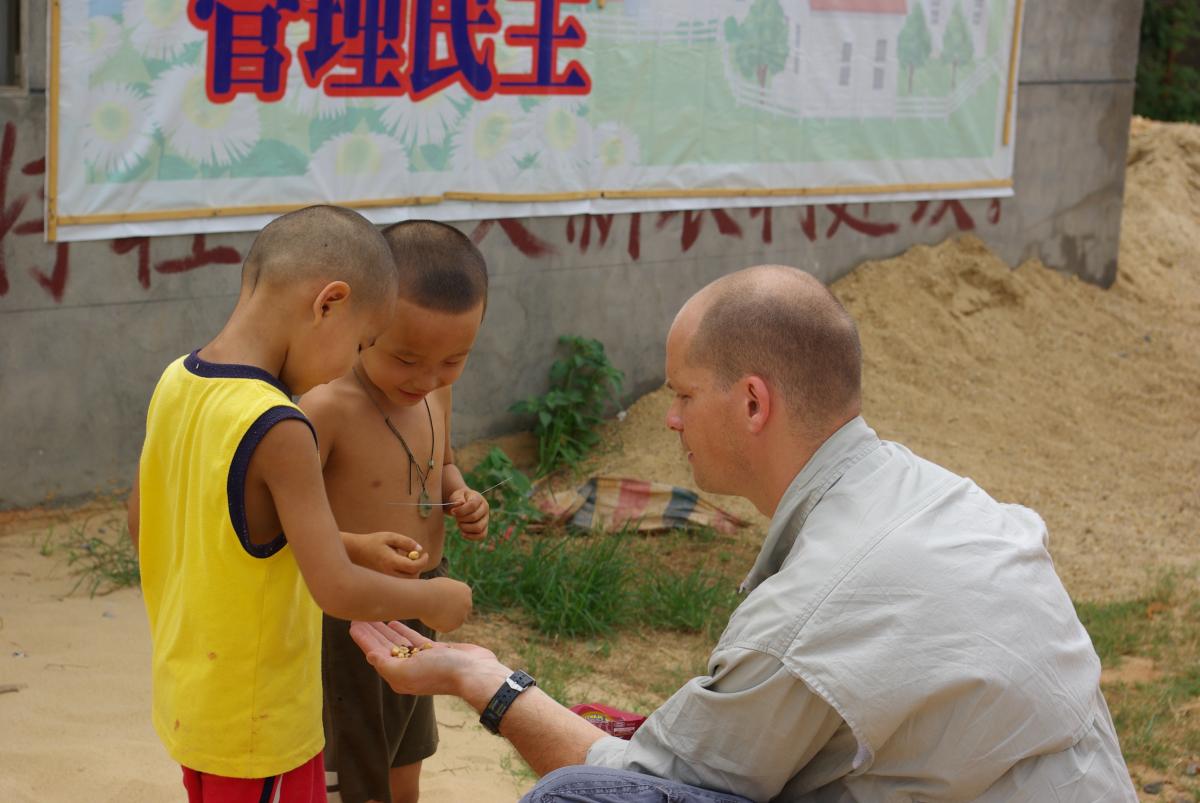 Sharing food with children rural villages outside of Jiujiang in Jiangxi Province in China.